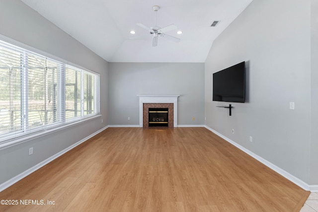 unfurnished living room with a fireplace with flush hearth, visible vents, and baseboards