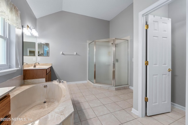 bathroom with a stall shower, tile patterned floors, a garden tub, vaulted ceiling, and vanity