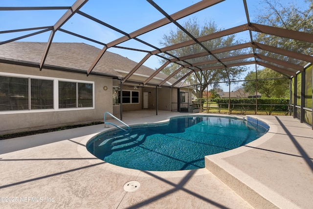 pool featuring a patio, glass enclosure, and a ceiling fan