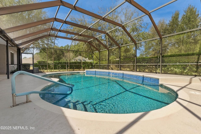 outdoor pool with a patio and glass enclosure
