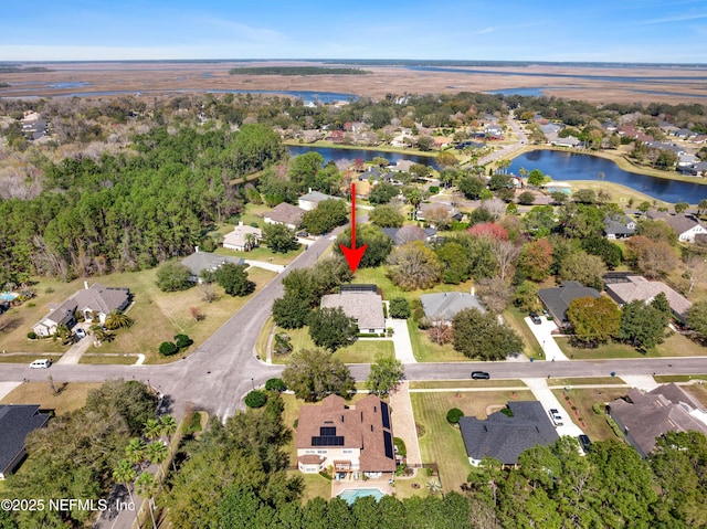 birds eye view of property featuring a residential view and a water view