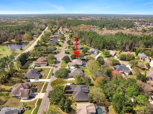 bird's eye view with a residential view, a water view, and a view of trees