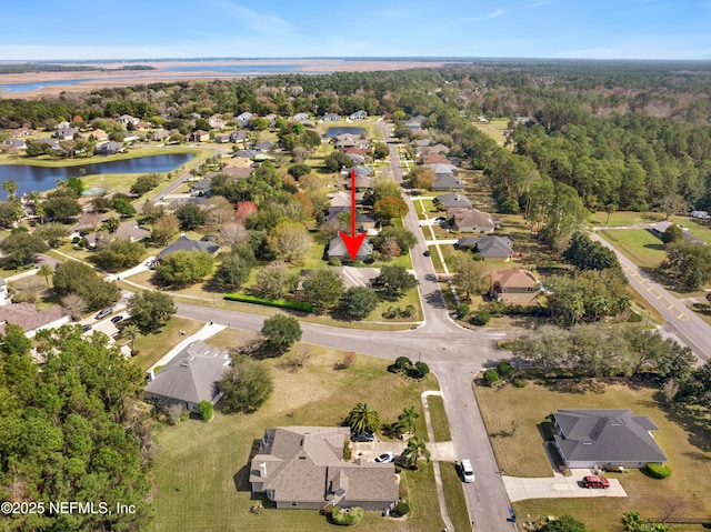 birds eye view of property featuring a water view and a residential view