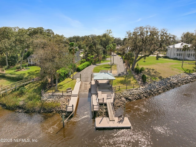 view of dock with a gazebo, a water view, and fence
