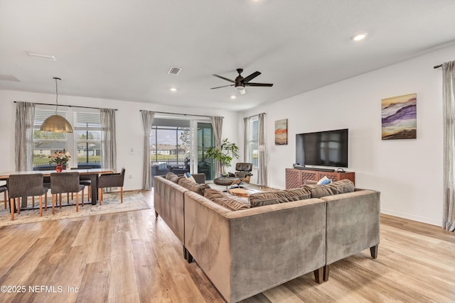 living area featuring light wood finished floors, visible vents, and recessed lighting