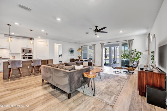 living area with french doors, light wood finished floors, recessed lighting, visible vents, and ceiling fan