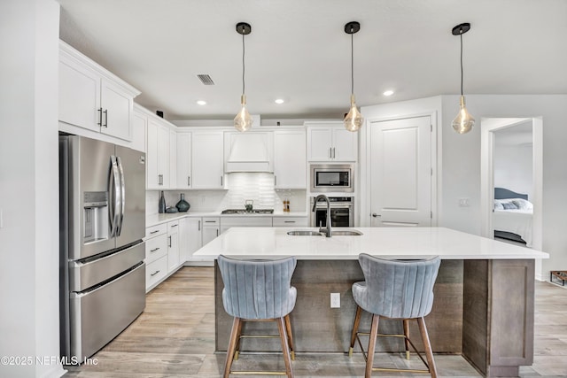 kitchen with appliances with stainless steel finishes, light countertops, and white cabinetry