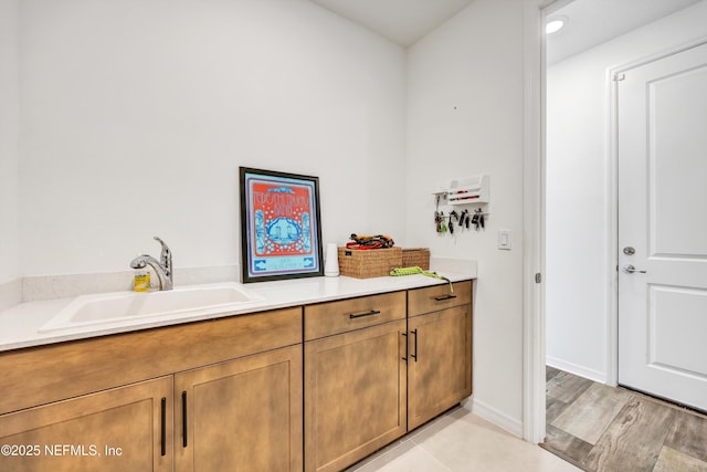 interior space with a sink and baseboards