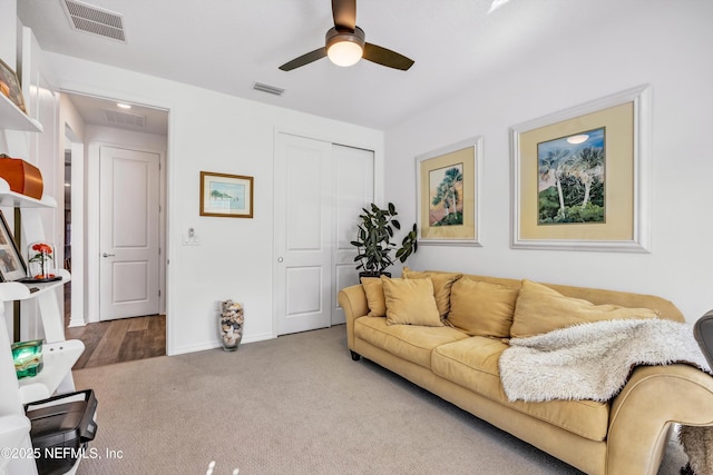 living area with a ceiling fan, carpet, visible vents, and baseboards