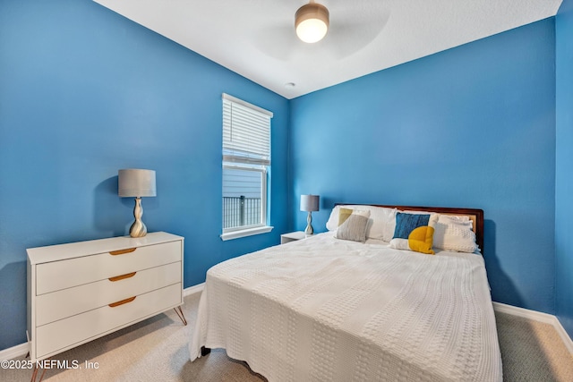 carpeted bedroom featuring ceiling fan and baseboards