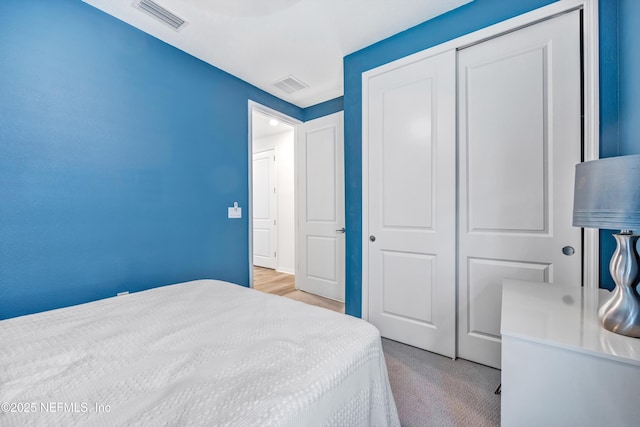 bedroom with visible vents and a closet