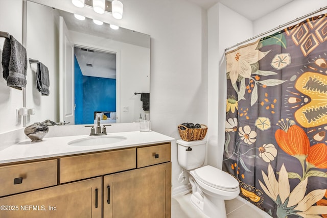 bathroom with vanity, toilet, and tile patterned floors