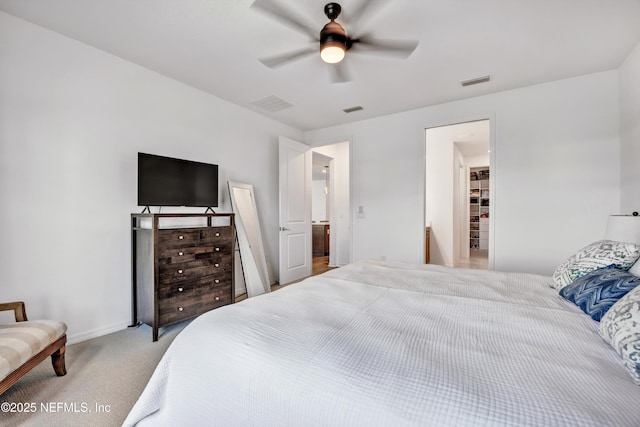 bedroom featuring a ceiling fan, light colored carpet, and visible vents