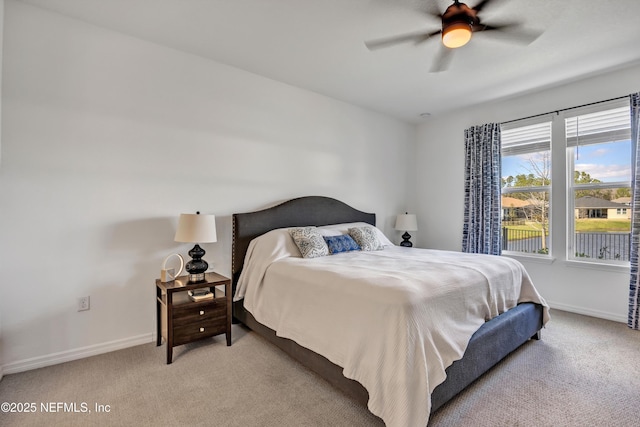 bedroom featuring light colored carpet, ceiling fan, and baseboards