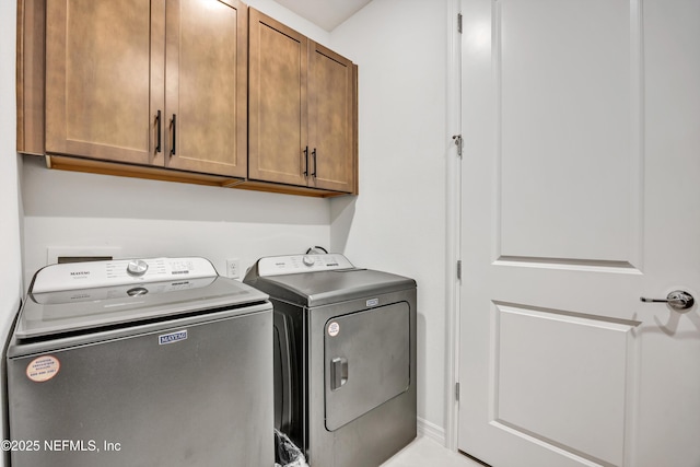 laundry area with washing machine and dryer and cabinet space