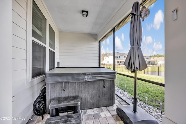 sunroom featuring a hot tub