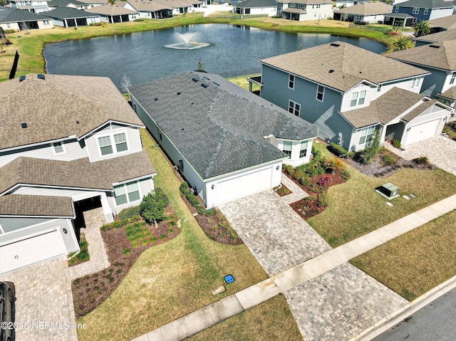 birds eye view of property with a water view and a residential view