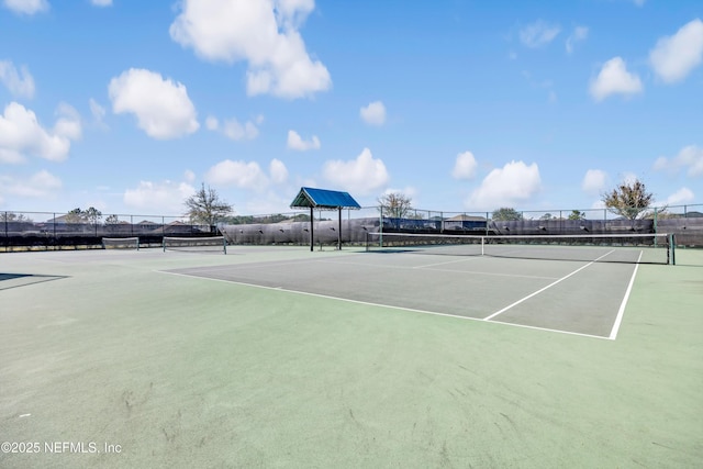 view of tennis court with fence