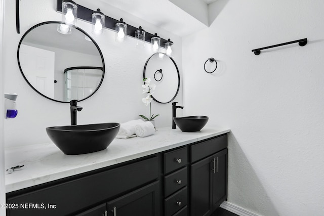 full bath featuring double vanity and a sink