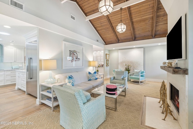 living area featuring wood ceiling, a warm lit fireplace, visible vents, and beamed ceiling