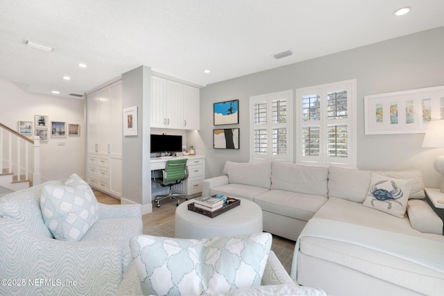 living room featuring stairway, recessed lighting, visible vents, and light wood-style flooring