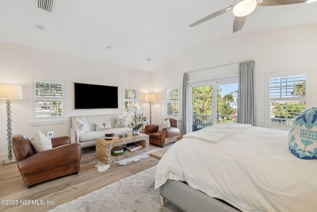 bedroom featuring visible vents, lofted ceiling, ceiling fan, wood finished floors, and access to exterior