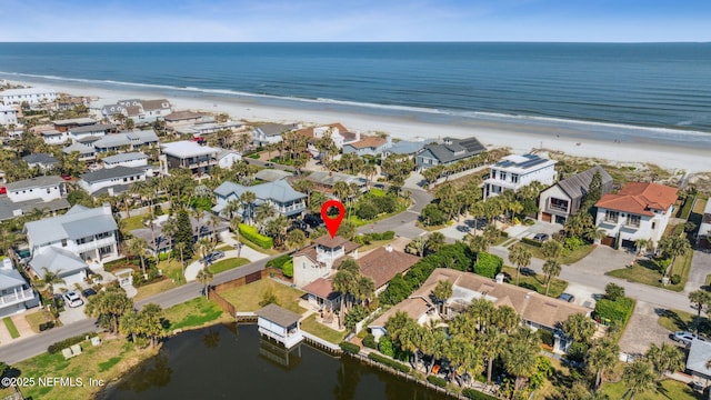 birds eye view of property featuring a water view, a residential view, and a view of the beach