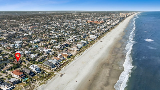 bird's eye view with a water view and a beach view