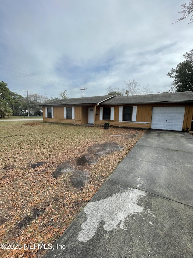 single story home with a garage and driveway