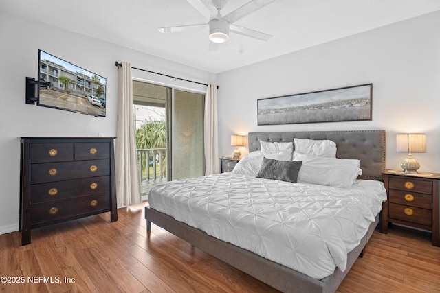 bedroom with access to outside, wood finished floors, and a ceiling fan