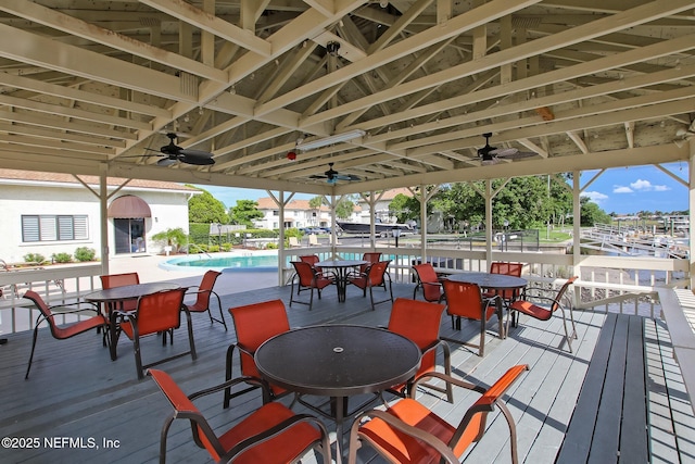 wooden deck with a community pool