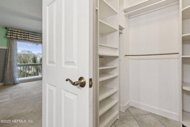 spacious closet featuring light tile patterned floors