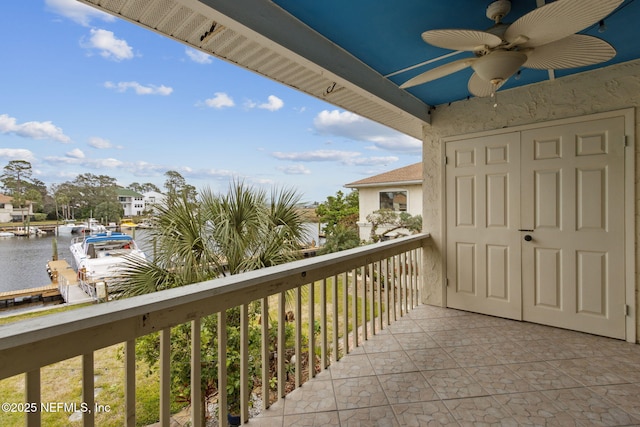 balcony featuring ceiling fan and a water view