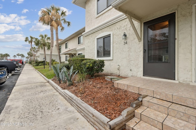 property entrance with stucco siding