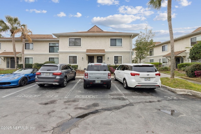 multi unit property with uncovered parking and stucco siding