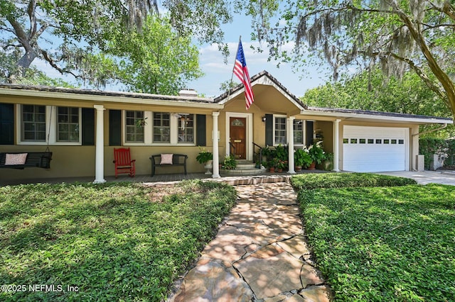 ranch-style house featuring driveway, an attached garage, and stucco siding