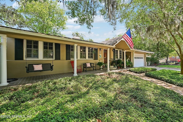 ranch-style home featuring an attached garage and stucco siding