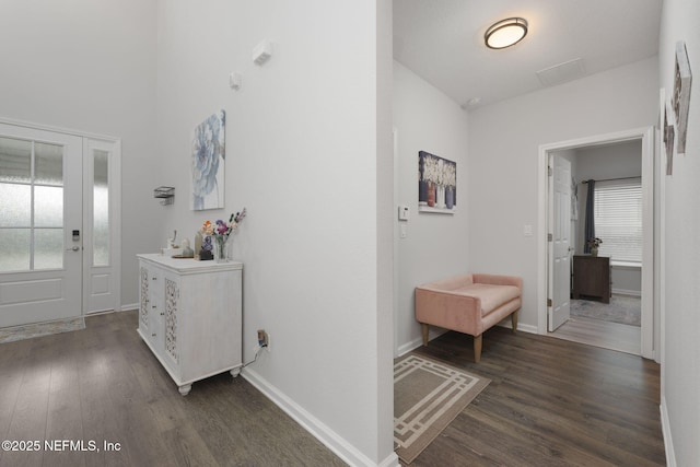 hallway with dark wood-type flooring and baseboards