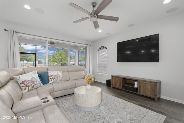 living area with baseboards, dark wood finished floors, and recessed lighting