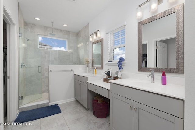 full bathroom featuring tile patterned flooring, recessed lighting, vanity, a shower stall, and a walk in closet