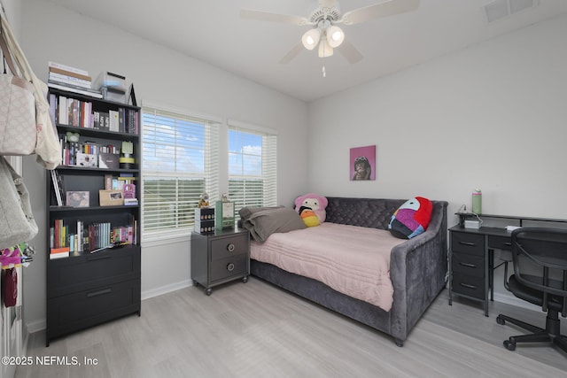 bedroom with ceiling fan, light wood-style flooring, visible vents, and baseboards