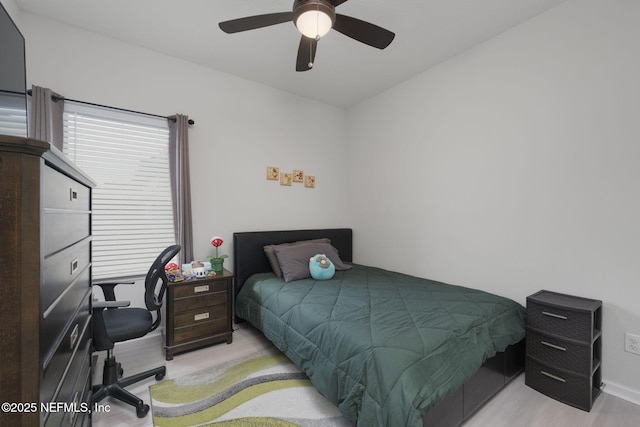 bedroom with a ceiling fan and light wood-style flooring