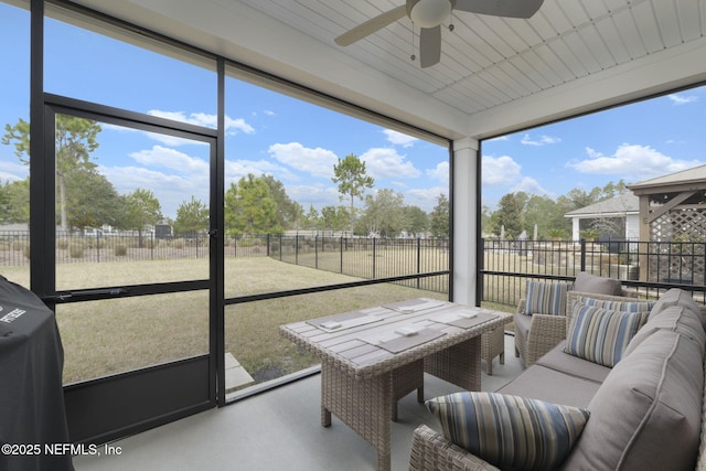 sunroom featuring ceiling fan