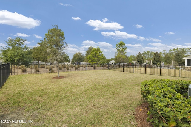 view of yard with a fenced backyard and a rural view