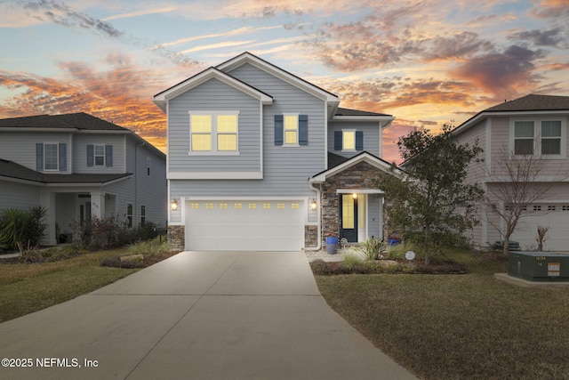 traditional-style house featuring a garage, stone siding, driveway, and a front lawn