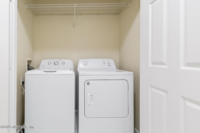 clothes washing area featuring laundry area and washing machine and dryer