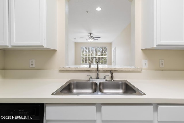 kitchen featuring black dishwasher, white cabinets, a ceiling fan, light countertops, and a sink