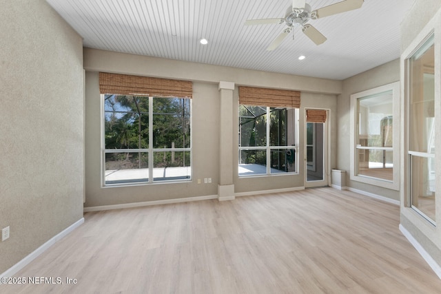 unfurnished room featuring baseboards, a healthy amount of sunlight, and light wood-style floors