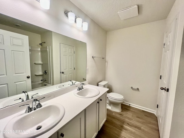 bathroom featuring bathtub / shower combination, a sink, and wood finished floors