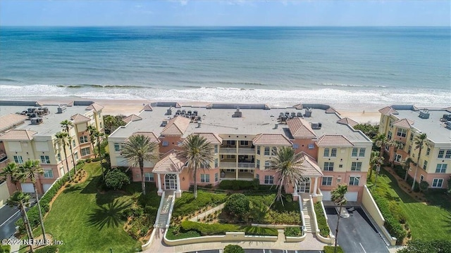 birds eye view of property featuring a water view and a view of the beach